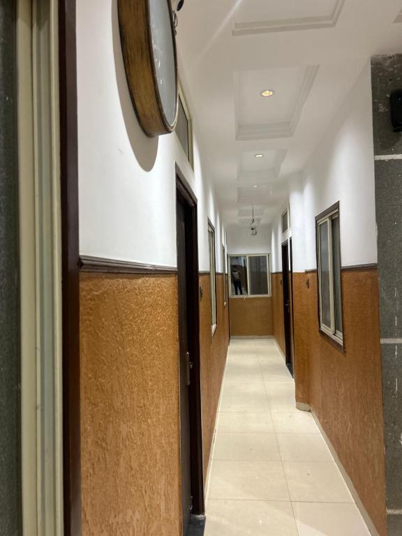 a hallway of a hospital with doors and a hallwayngth at Hotel JT in Indore