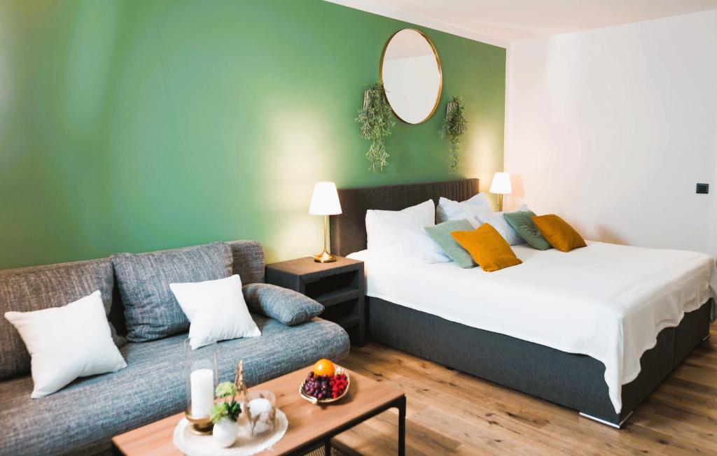 a bedroom with a bed and a couch at Lakeside Lodge mit Seeblick am Kranichsee in Goslar