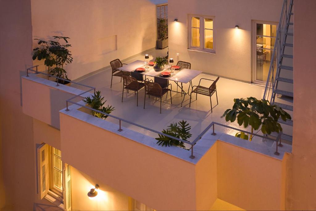 a balcony with a table and chairs in a building at Vava Residence in Heraklio