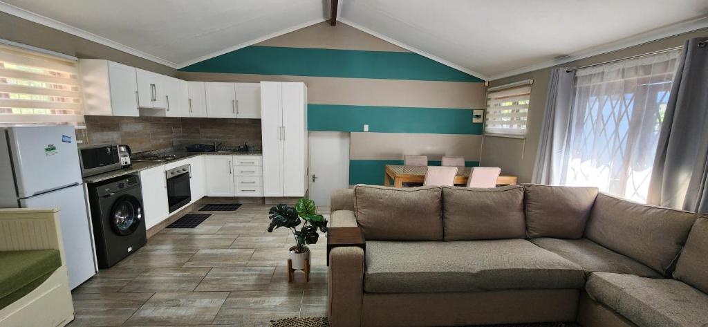 a living room with a couch and a kitchen at Westbrook Hideaway in Westbrook