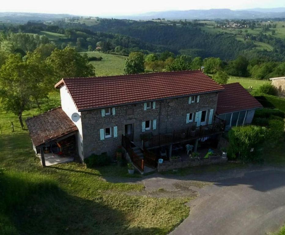 an aerial view of a house in a field at La P'tite Chaumiere in Domaize
