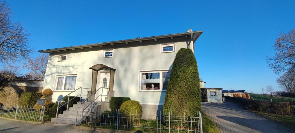 a white house with a fence in front of it at Labahn in Lohme