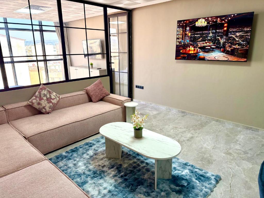 a living room with a couch and a table at Studio luxueux avec vue panoramique sur le centre ville in Fez