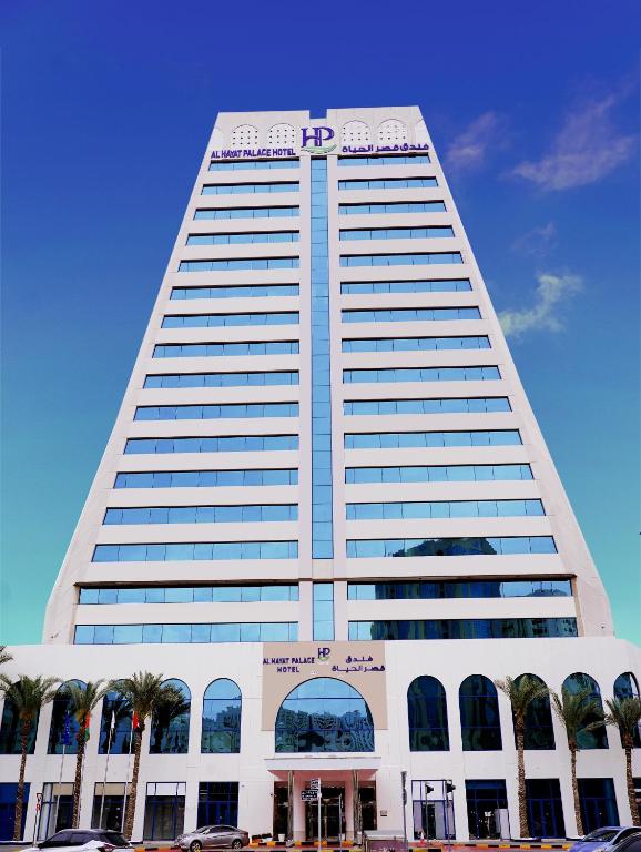 a tall white building with a pepsi sign on it at Al HAYAT PALACE HOTEL in Sharjah