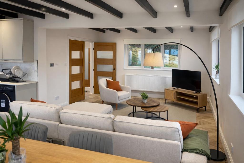 a living room with a couch and a table at Valdermosa in Newlyn