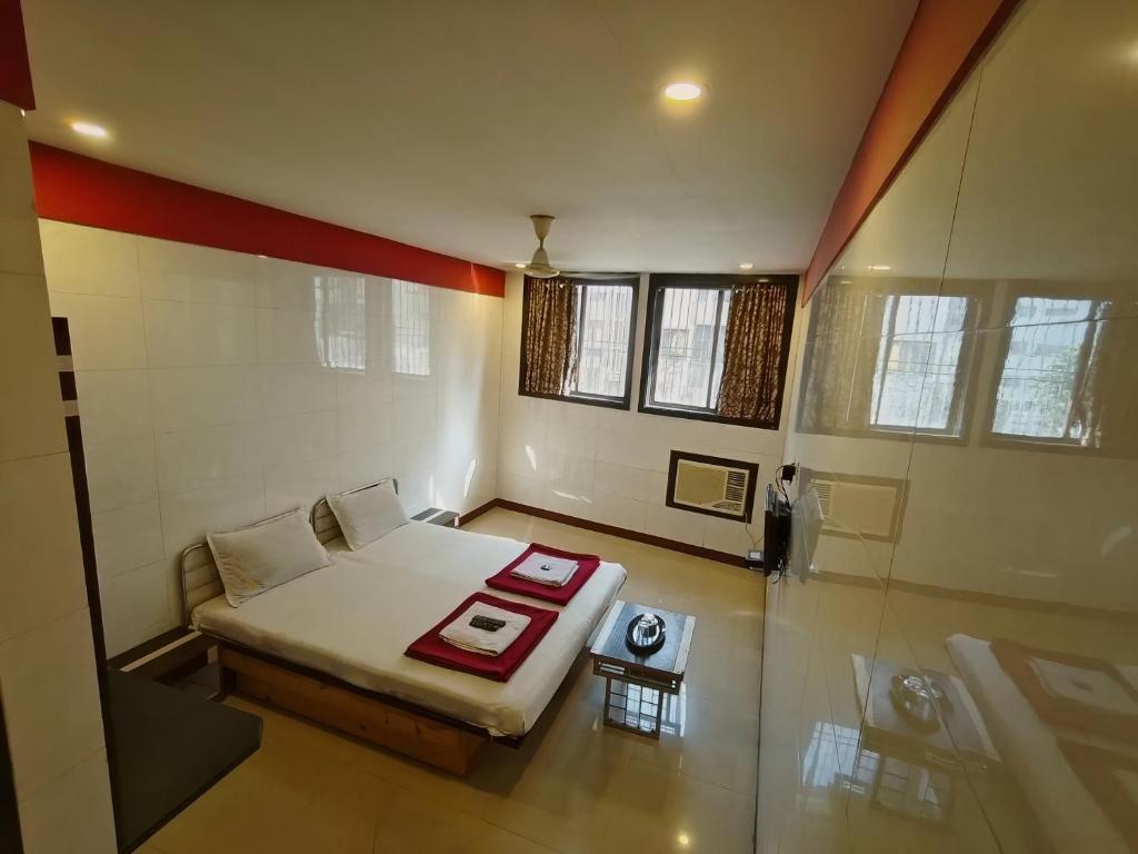 a small room with a bed and a table at Hotel Vishal - Near Surat Railway Station in Surat