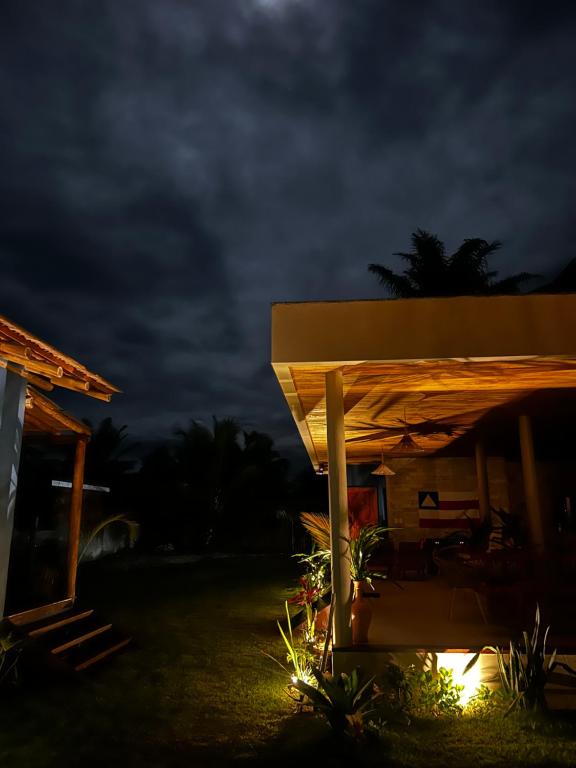 a night view of a house with a roof at Vila Saquaira in Marau