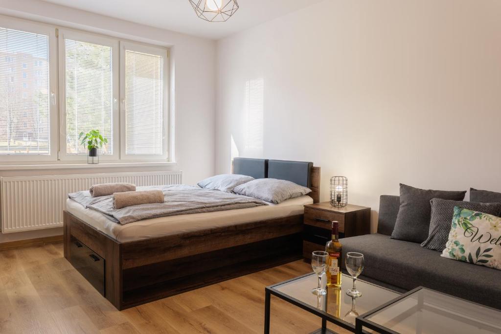 a living room with a bed and a couch at Apartment Spišská Nová Ves in Spišská Nová Ves