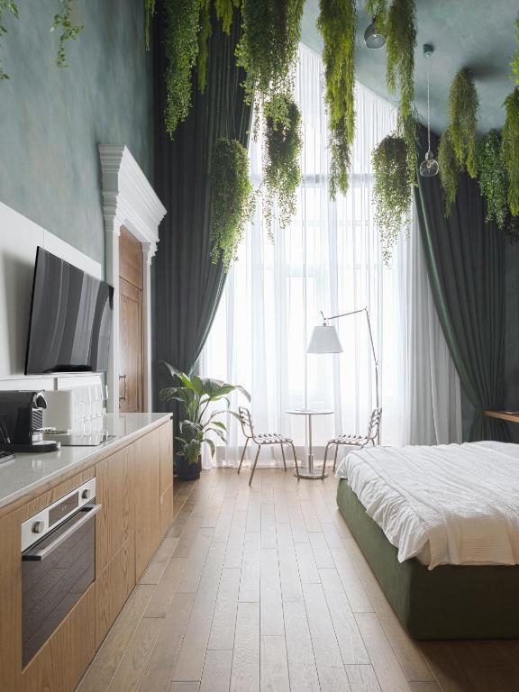 a bedroom with a bed and a tv and a window at Lesi City Guide Hotel in Kyiv