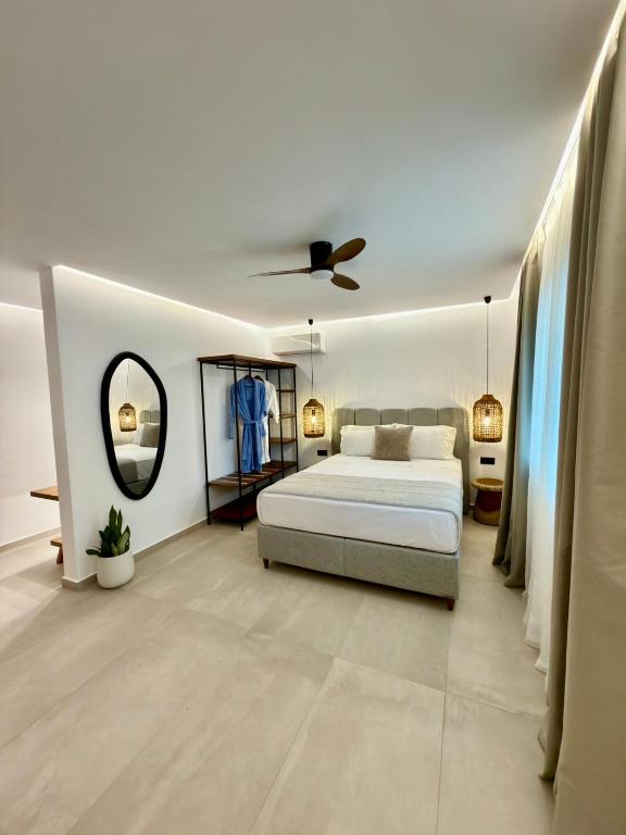 a bedroom with a bed and a ceiling fan at Alexis Suites Olympus in Litochoro