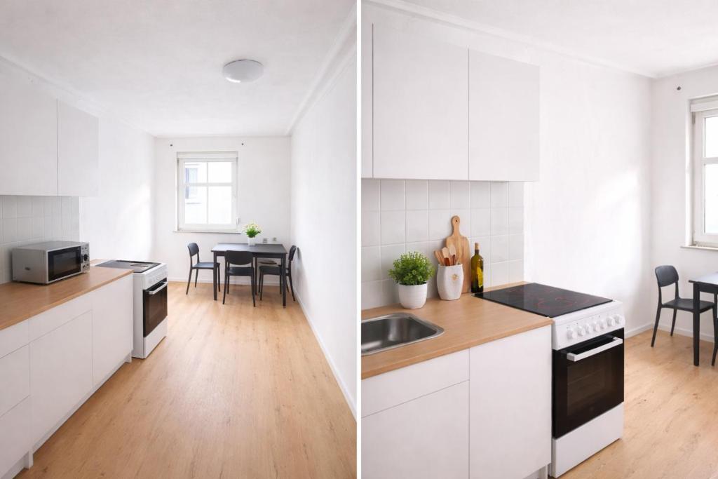 a kitchen with white cabinets and a dining room at Monteurapartments in Heidenheim NEU Küche Smart TV WIFI in Heidenheim an der Brenz