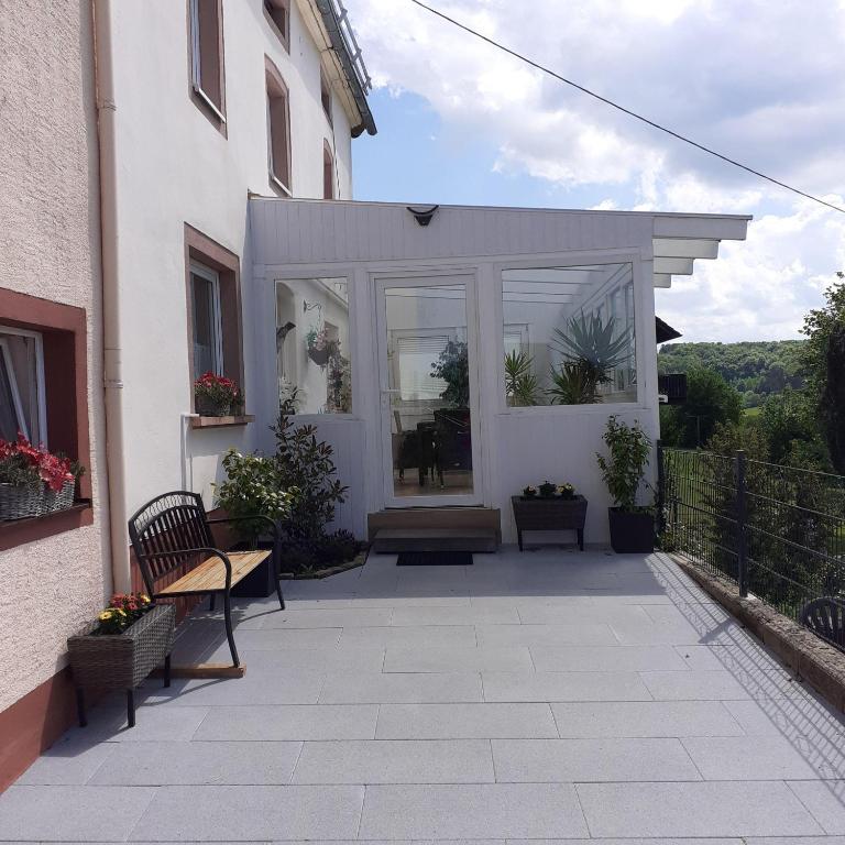 a patio with a bench and a building at Ferienhaus-Feinen in Lierfeld