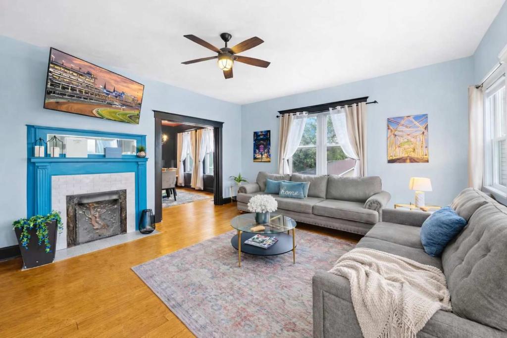 a living room with a couch and a fireplace at Riverview Escape in Walkable Historic District in Jeffersonville