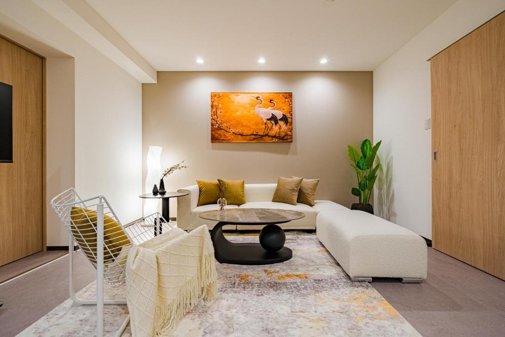 a living room with a white couch and a table at AoiResidence別邸葵 in Nagoya