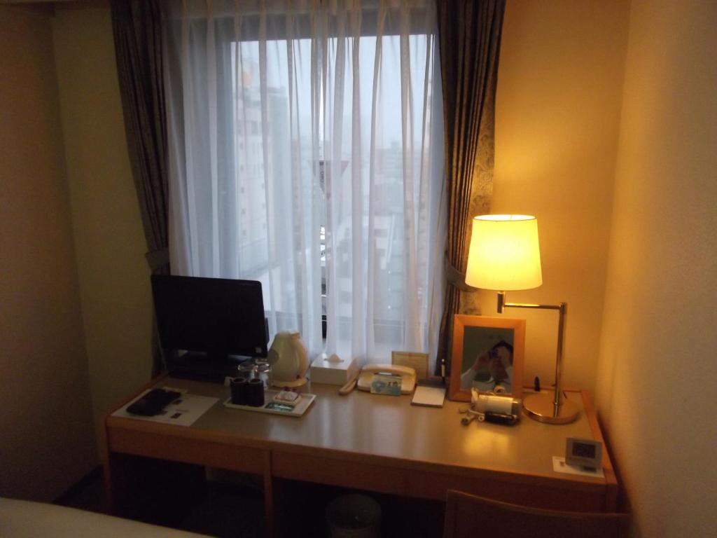 TV a/nebo společenská místnost v ubytování Ichikawa Grand Hotel