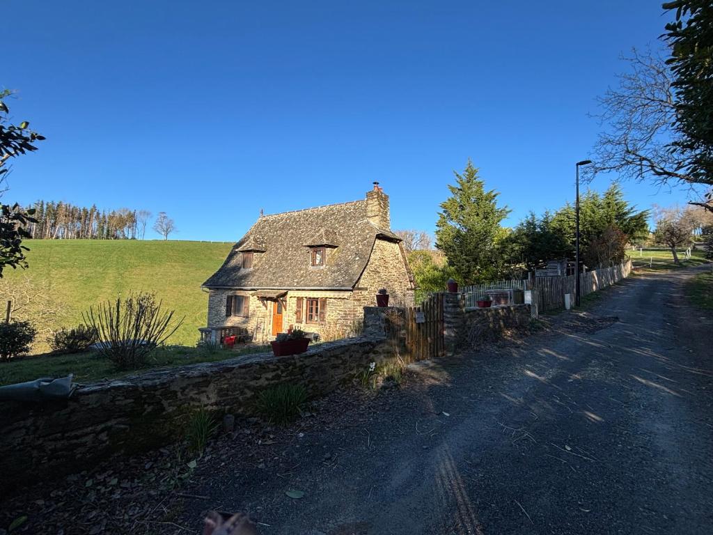 an old stone house on the side of a road at Lacouty le paradis! in Junhac