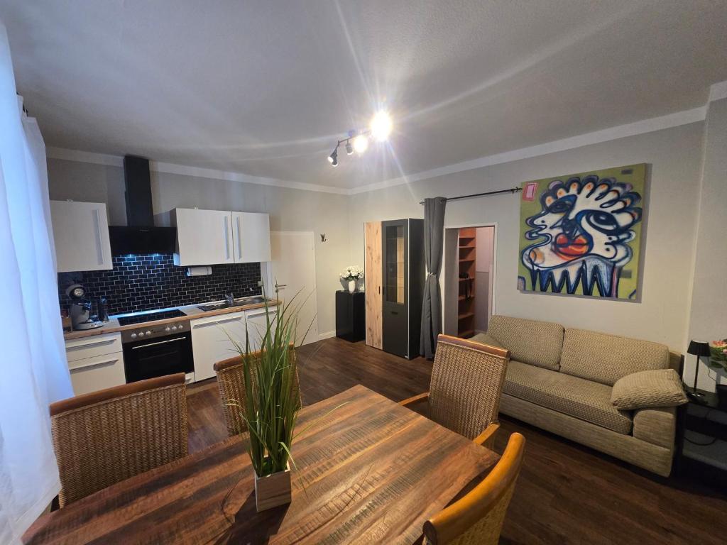 a kitchen and living room with a table and a couch at Appartement Neckartal in Hirschhorn