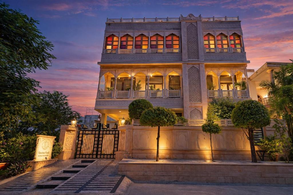 a large house with a fence in front of it at Harnawa Haveli - A Boutique Heritage Stay in Jaipur in Jaipur