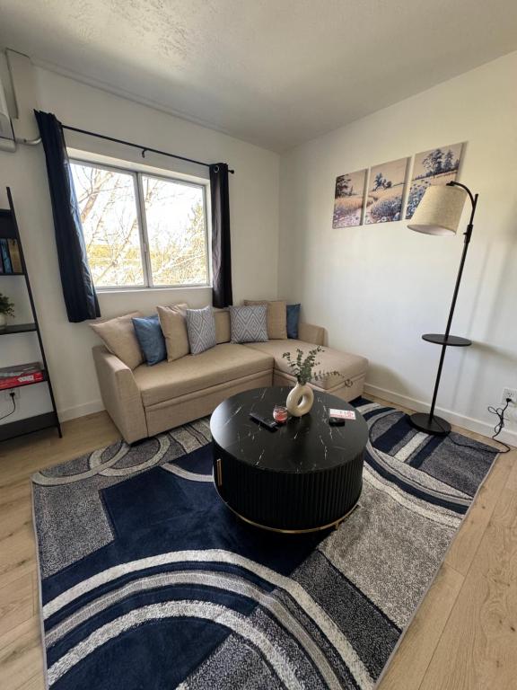 a living room with a couch and a table at Cozy blue house in Salt Lake City