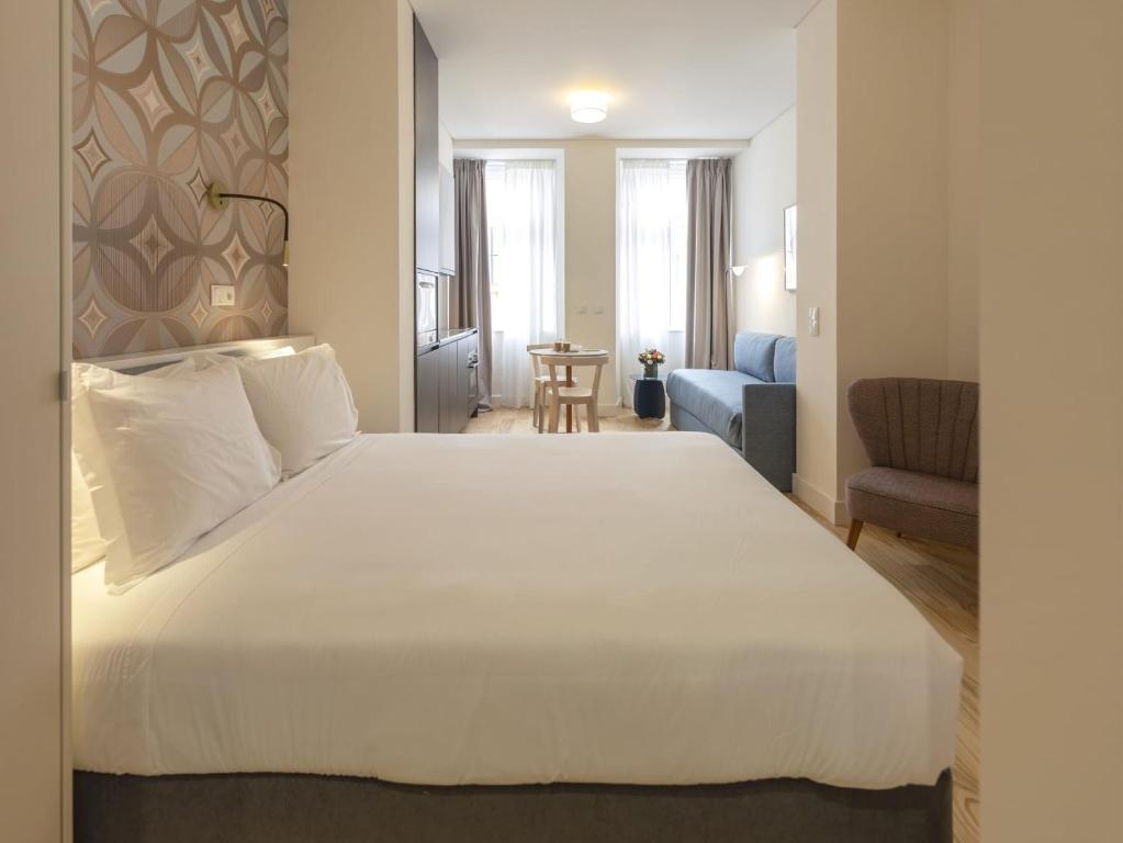 a bedroom with a large white bed in a room at LSA Santos by Numa in Lisbon