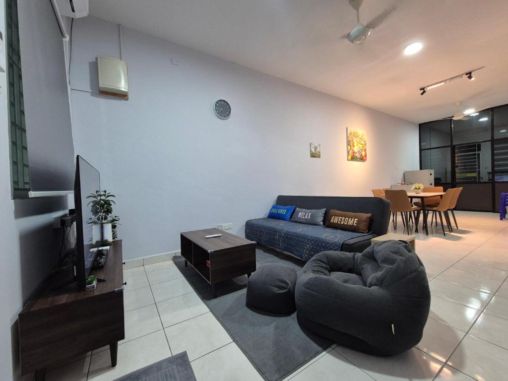 a living room with a couch and a table at Lim'S Homestay Kudat in Kudat