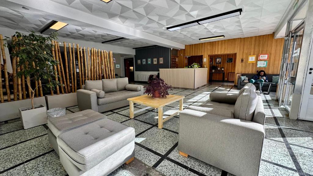 a lobby with couches and chairs and a table at NBH Premier Hotel in San Carlos de Bariloche