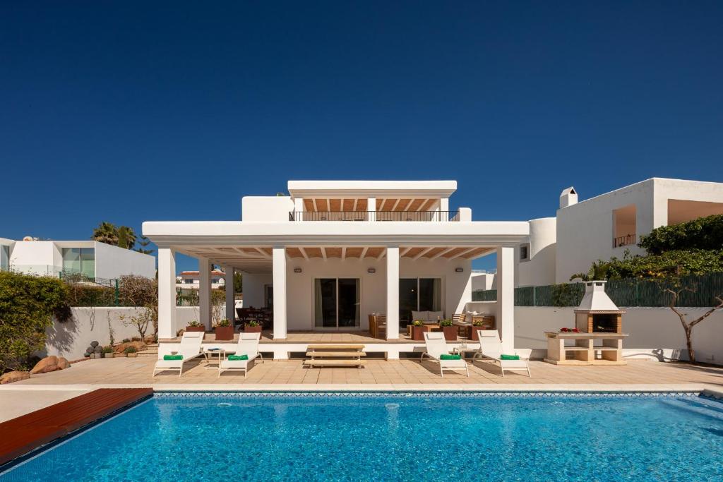 a villa with a swimming pool in front of a house at New! Villa Lina in Santa Gertrudis de Fruitera