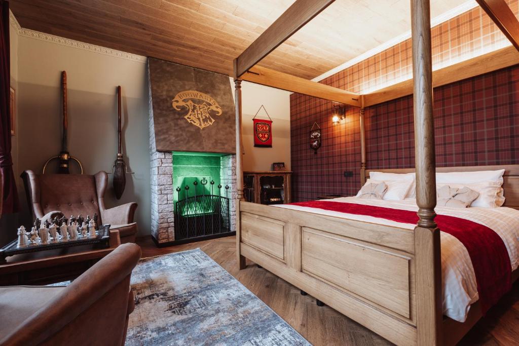 a bedroom with a large bed and a fireplace at La Baguette du Sorcier - Logement insolite immersif jusque 4 personnes entre Liège & Maastricht in Visé