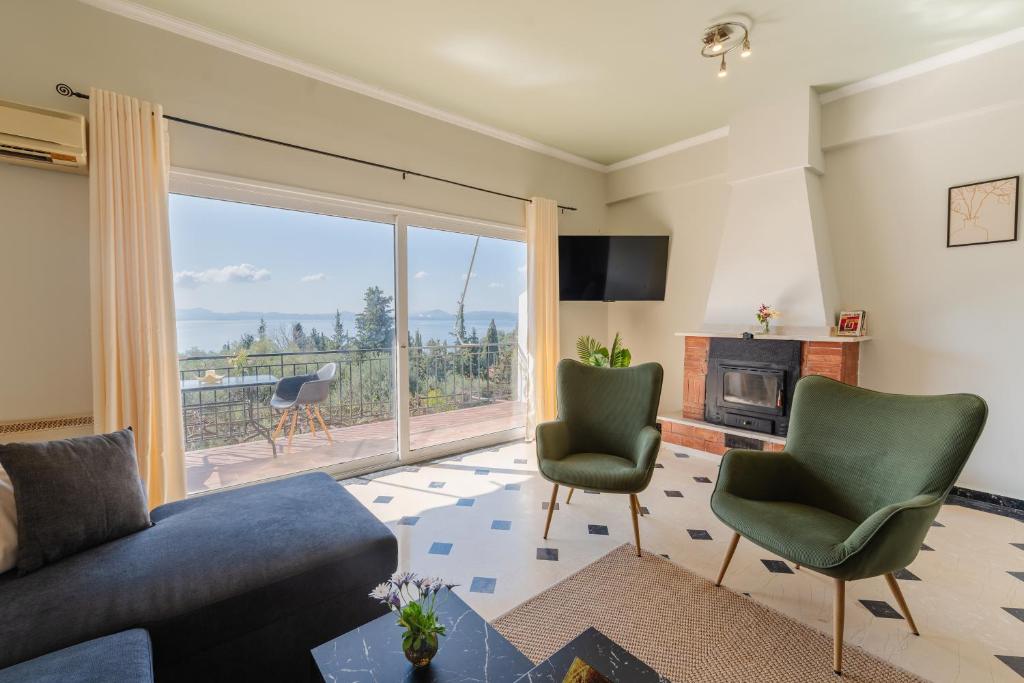 a living room with a couch and chairs and a fireplace at The 7 Trees Apartments by Konnect, Nisaki in Nisaki