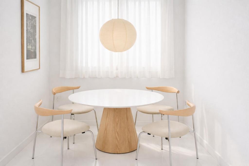 a white dining room with a white table and chairs at Stay Noop in Gyeongju