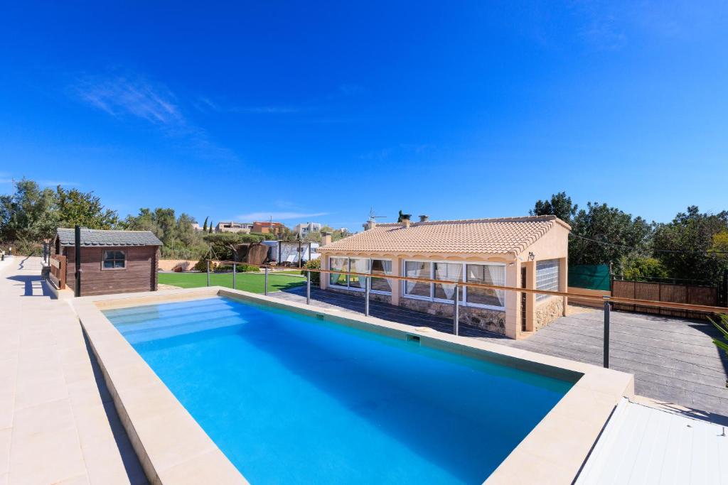 a large swimming pool in front of a house at Hauzify I Mas Blau in L'Ametlla de Mar