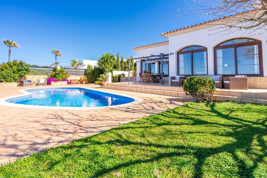 a house with a swimming pool in the yard at Sa Torre Voramar in Sa Torre