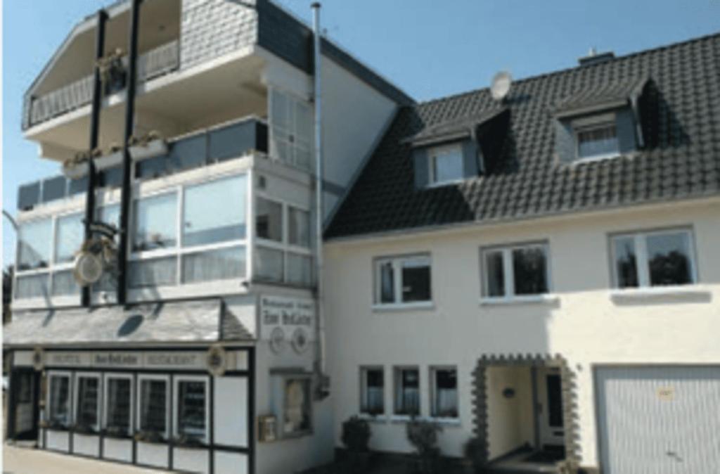 a large white building with a black roof at Hotel Zum Holländer in Lindlar