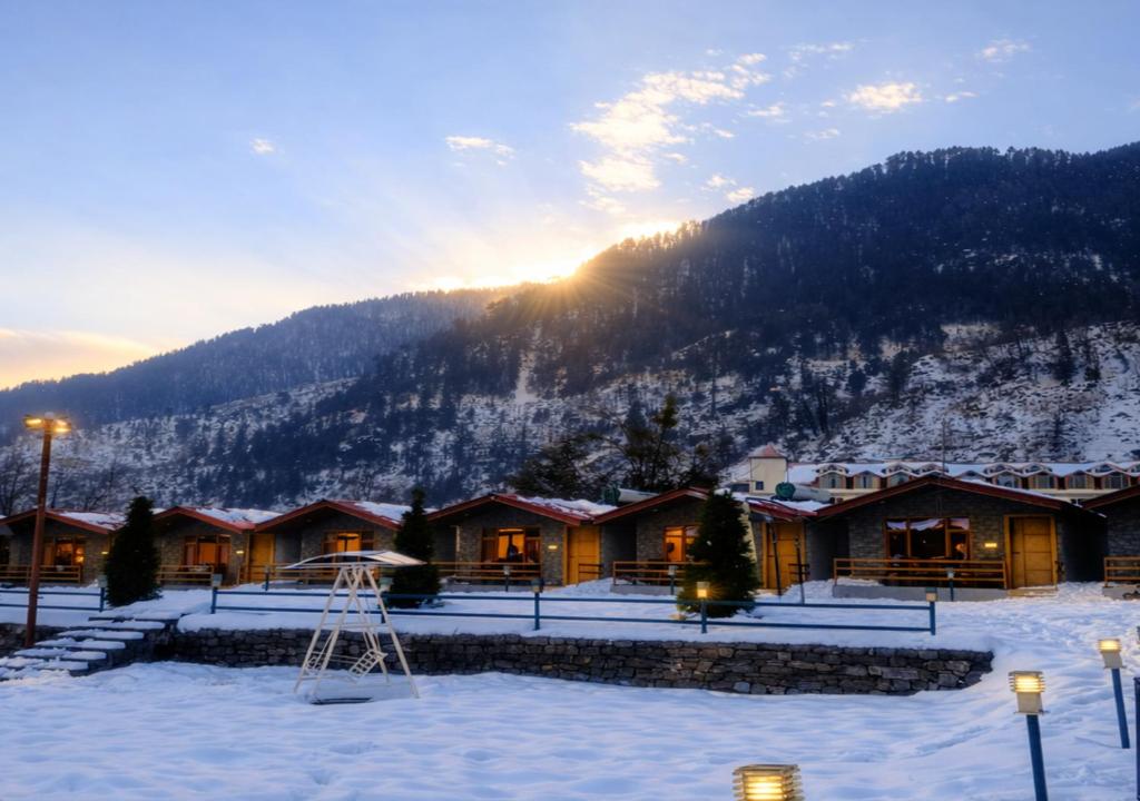 a lodge in the mountains with snow on the ground at Flora Hills Manali in Jagatsukh