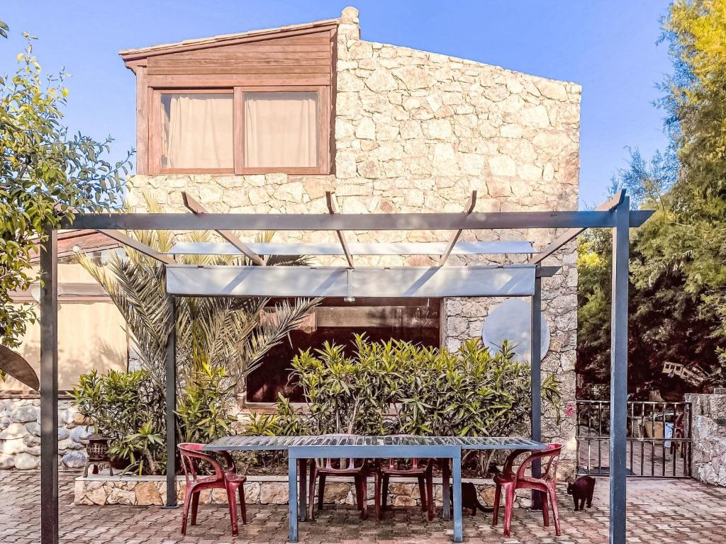 a table and chairs in front of a building at Holiday Home Posidonie by Interhome in LʼÎle-Rousse