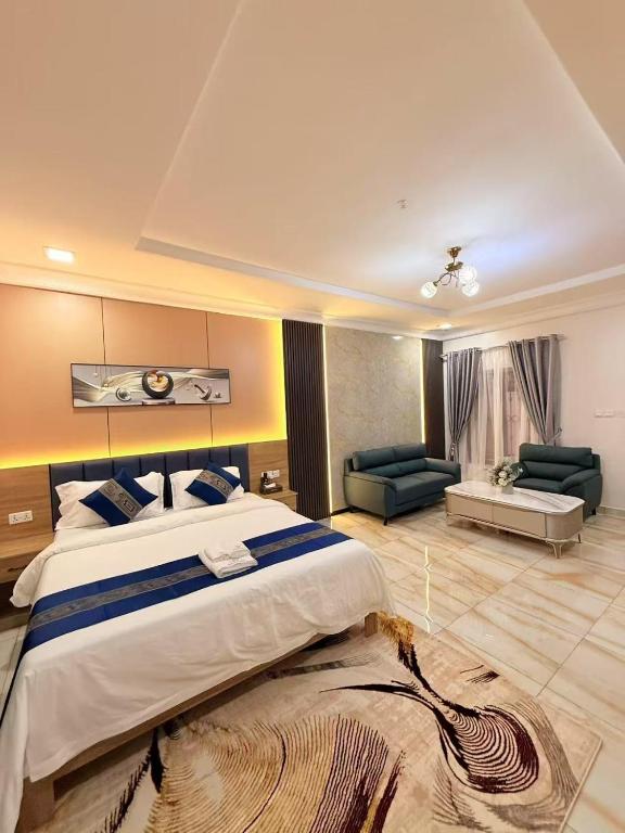 a large bedroom with a large bed and a living room at Star Wish Business Hotel in Lagos
