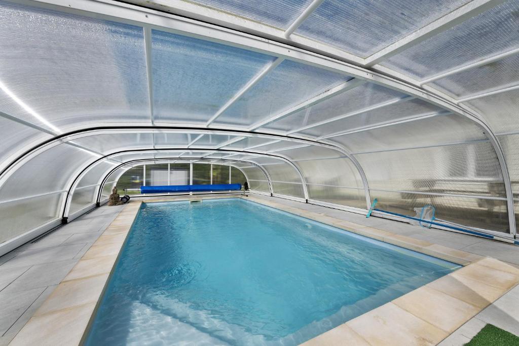 an indoor swimming pool with an open tunnel at Maison d'Elise in Kerlouan