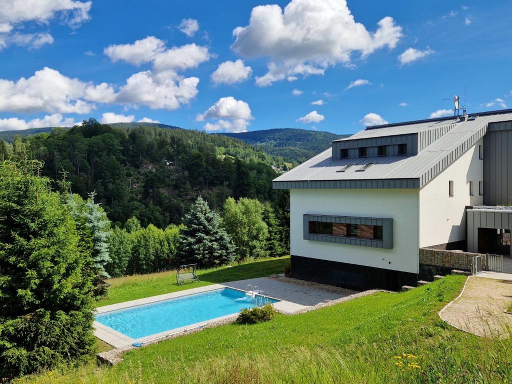 an aerial view of a house with a swimming pool at Studio Mountain Luxe Nest & Pool by Interhome in Rokytnice nad Jizerou