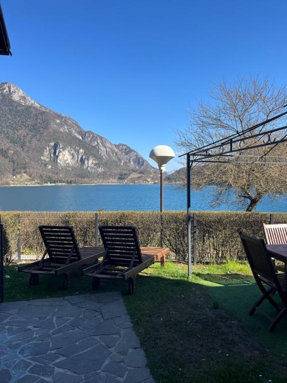 two chairs and a table with a view of a lake at Cà Serena Panoramic Garden - Appartamento Greta in Ledro