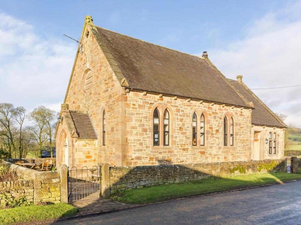 an old stone church with a fence in front of it at 3 Bed in Buxton oc-52891 in Sheen