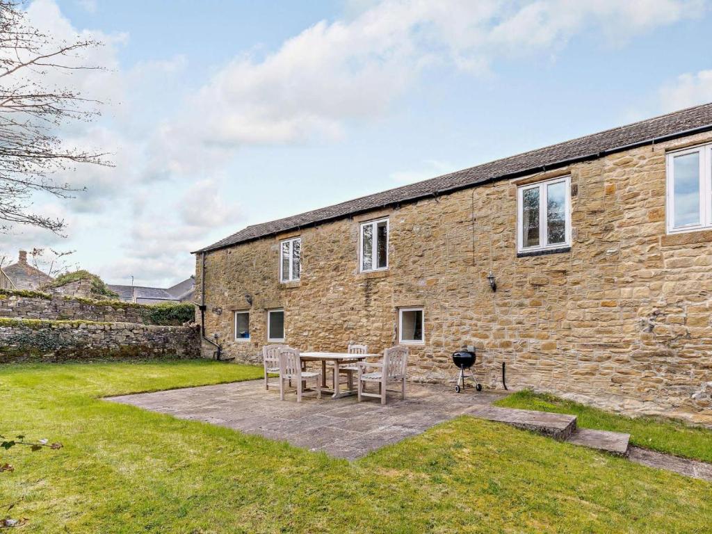 a brick building with a table and chairs in front of it at 3 Bed in Eyam oc-pk835 in Eyam
