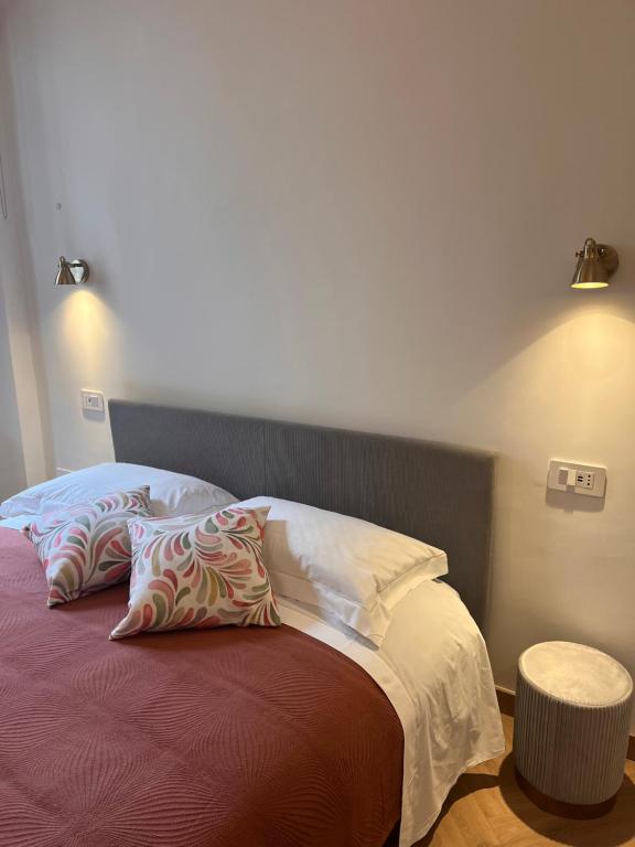 a bedroom with a bed with two pillows on it at Piazza Sant'Agostino Rooms in Bagnoregio