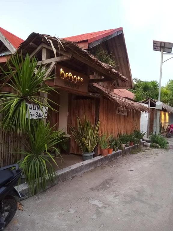a building with a sign for a barbershop at Bebot's Breakfast #01 in Daanbantayan