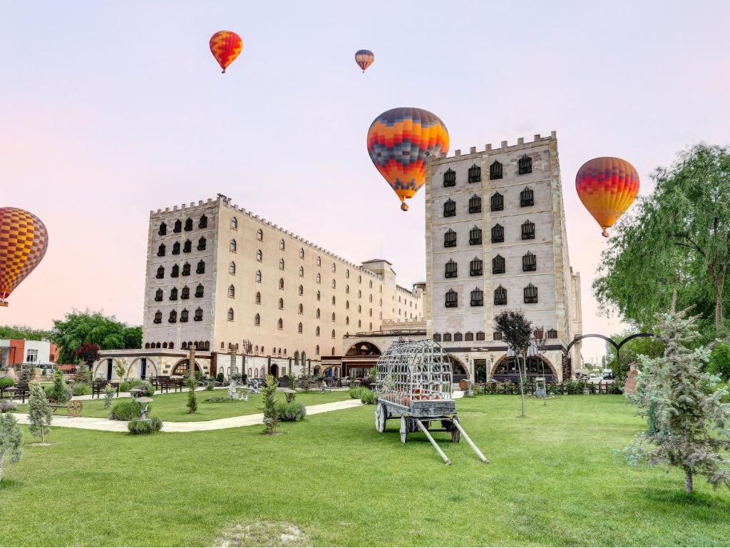 a group of hot air balloons flying over a park at Suhan Cappadocia Hotel & Spa in Avanos