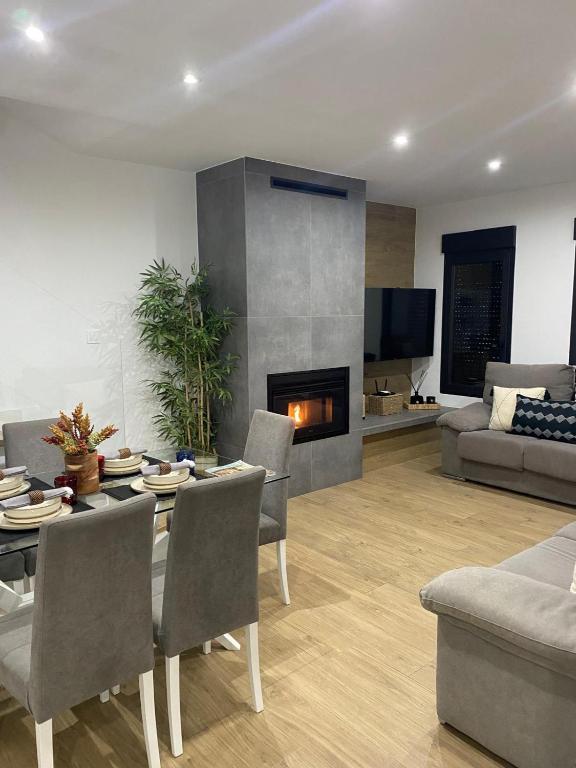 a living room with a table and a fireplace at Center Luxury Chalet Mazagón in Mazagón