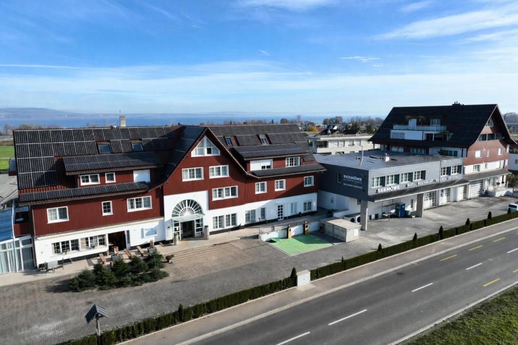 a group of buildings on the side of a road at Seemöwe Wellnesshotel Swiss Quality in Güttingen