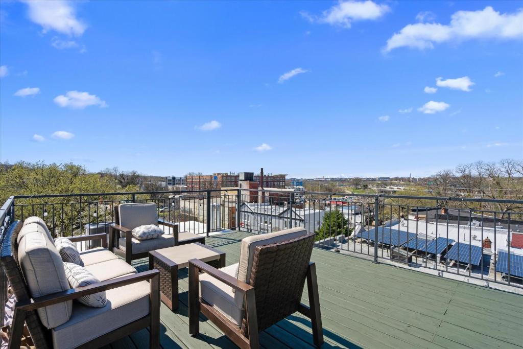 a balcony with chairs and tables on a roof at Entire DC House 3BR 3BA RoofDeck Free Parking Near Capitol Hill in Washington, D.C.