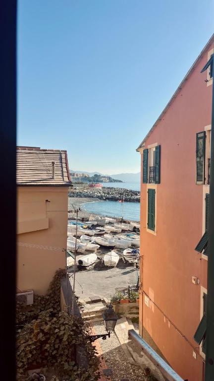 a group of boats in the water between two buildings at Casa sulla spiaggia in Genoa
