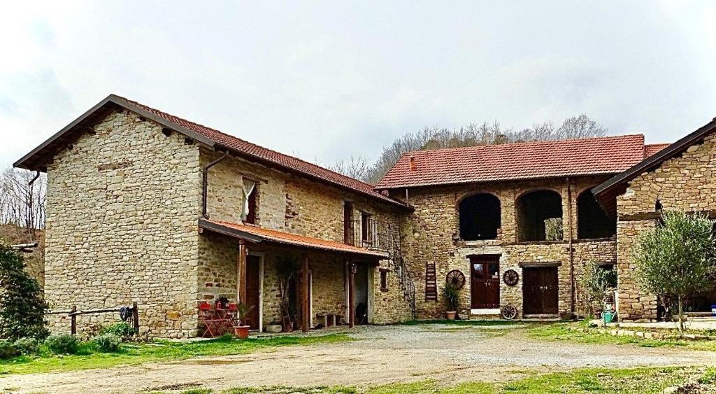 an old brick building with a red roof at BeB La Bergera in Cessole