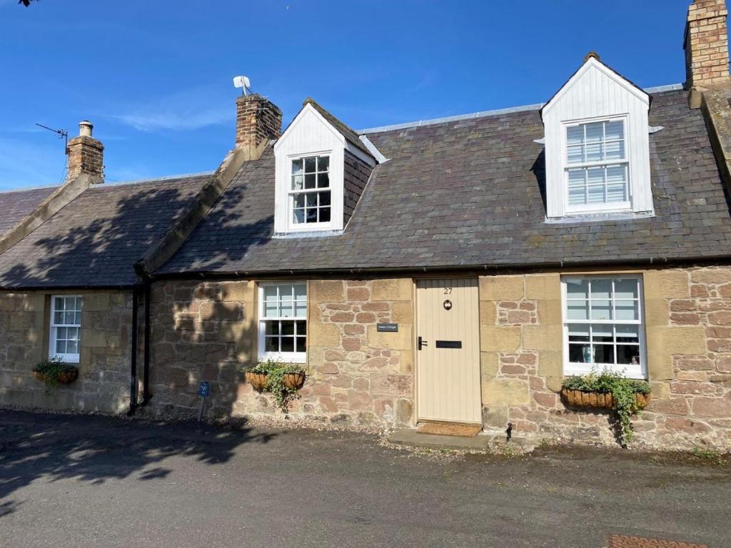 an old stone house with white windows and a door at 3 Bed in Duns oc-89133 in Swinton